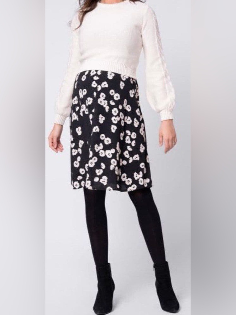 Floral black and white maternity Seraphine dress with white matching sweater.